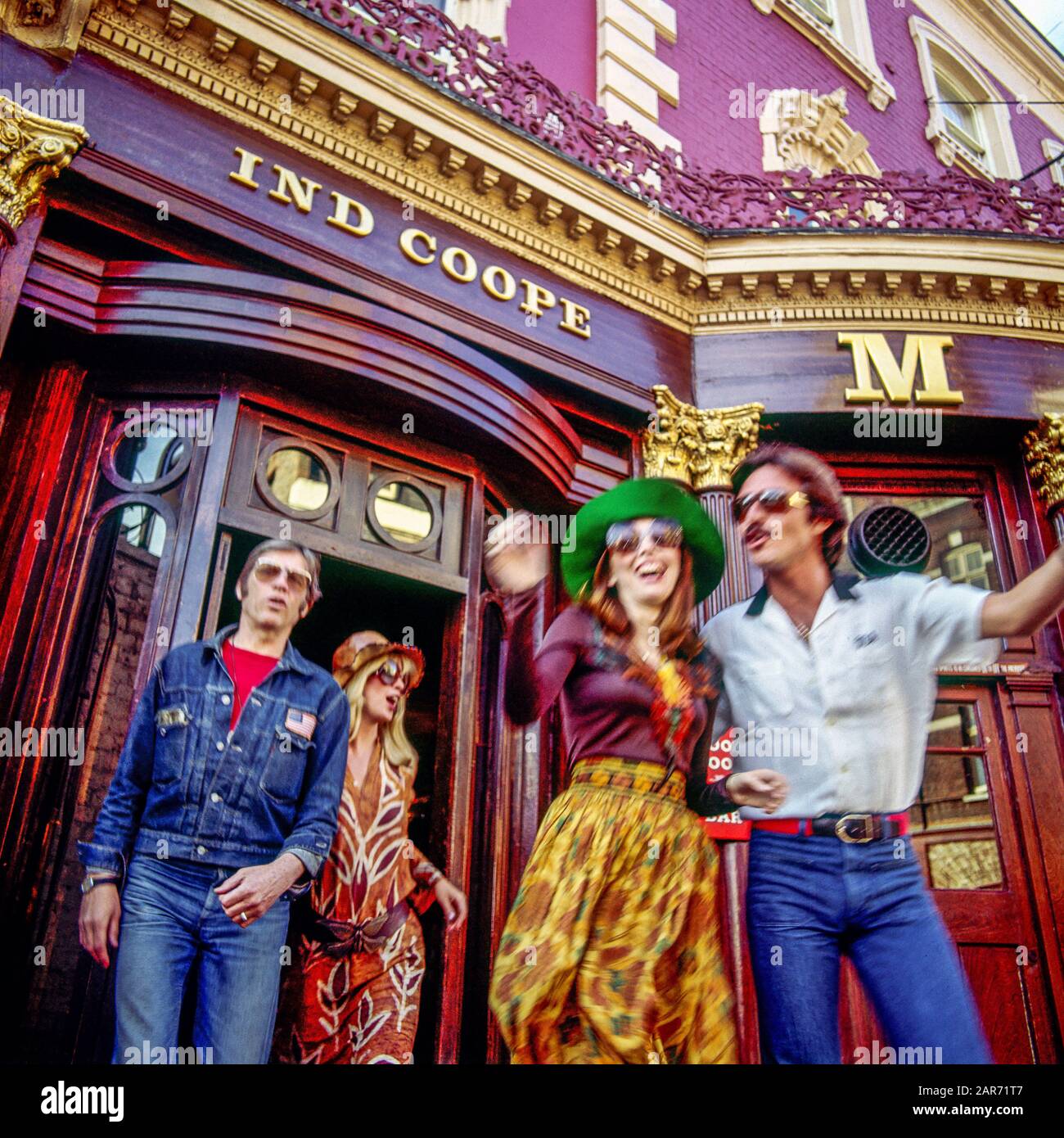 London 1970s, exuberant moving people coming out from Ind Coope Markham Pub, Kings Road, Chelsea, England, UK, GB, Great Britain, Stock Photo