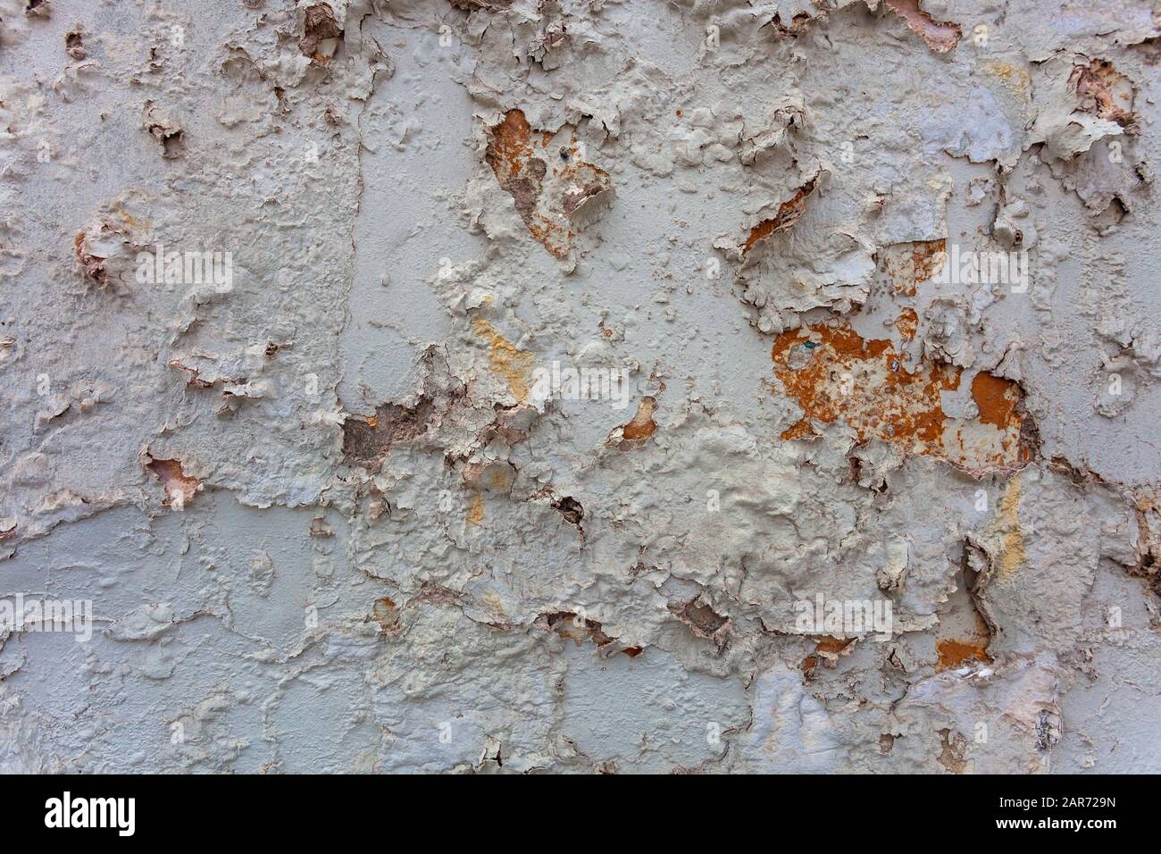 Old cracked paint on the wall faded blue with orange spots, background