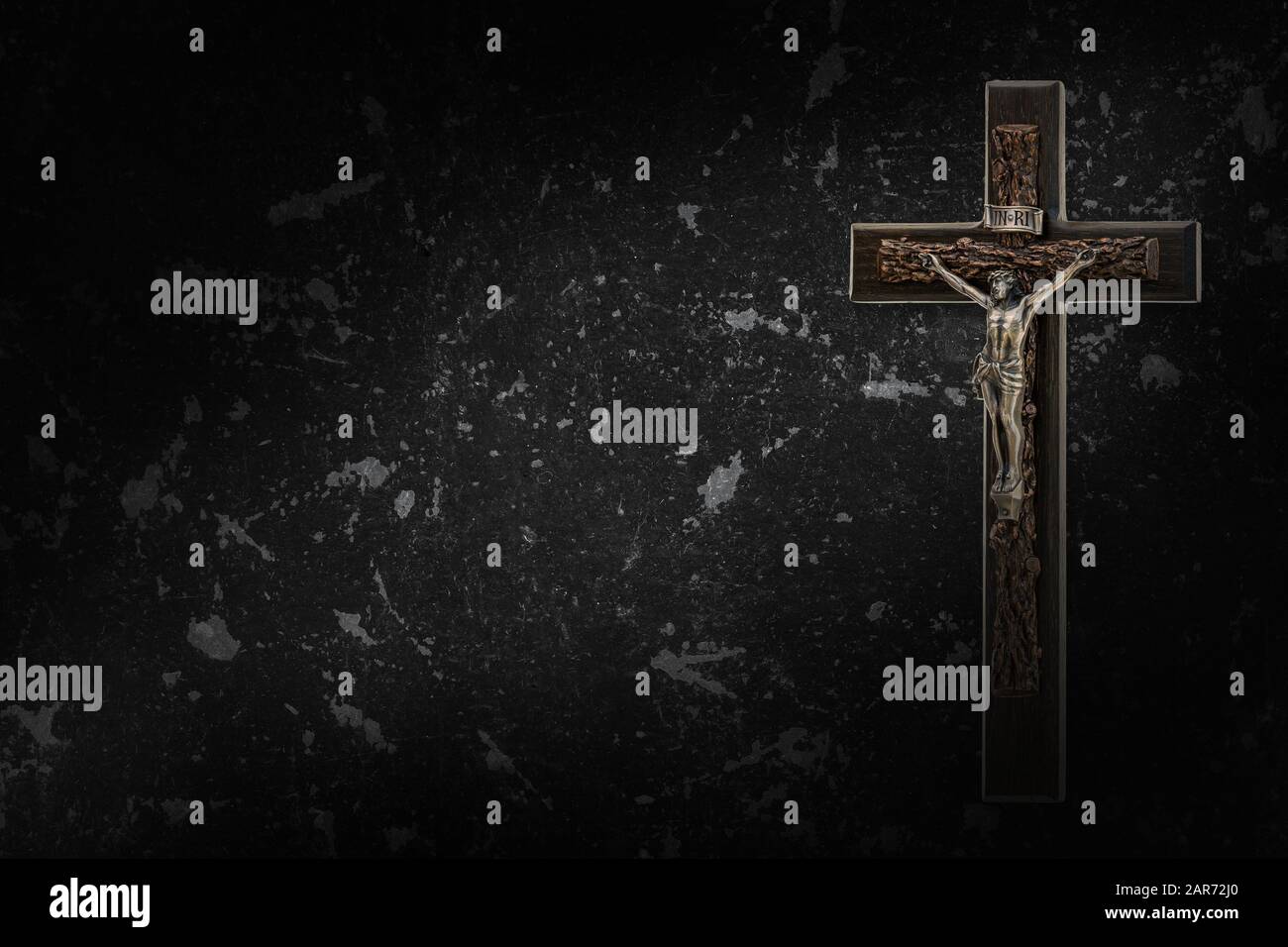 The Crucifix of Jesus Christ hanged on black concrete wall background ...