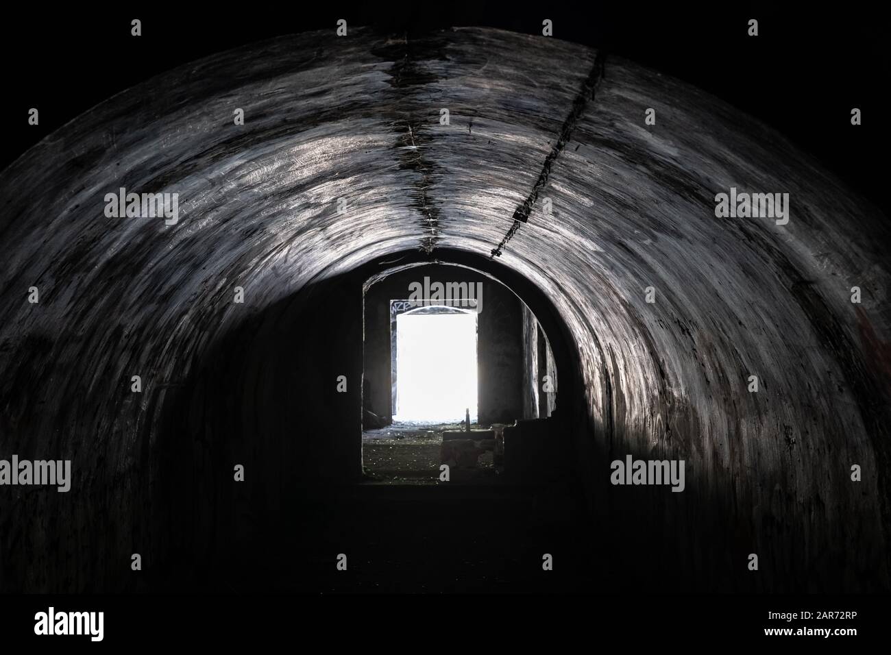 Spooky, creepy arched passage in an abandoned building, old military fort interior concrete structure, urban exploration Stock Photo