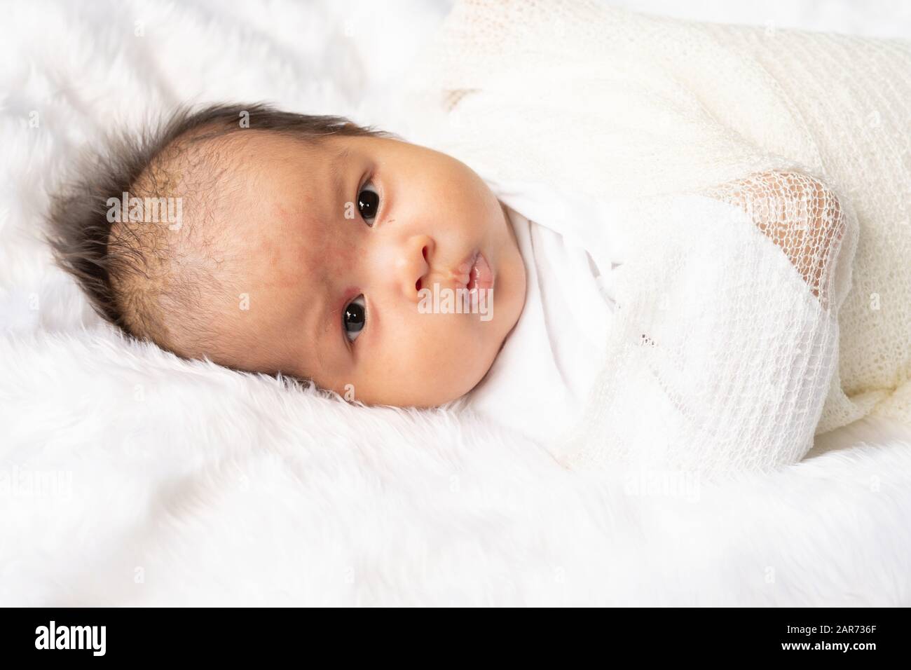 Cute newborn baby girl in white blanket on nursery bed. Adorable new born  child, little boy eyes look people Family, new childhood, infant soft skin p  Stock Photo - Alamy