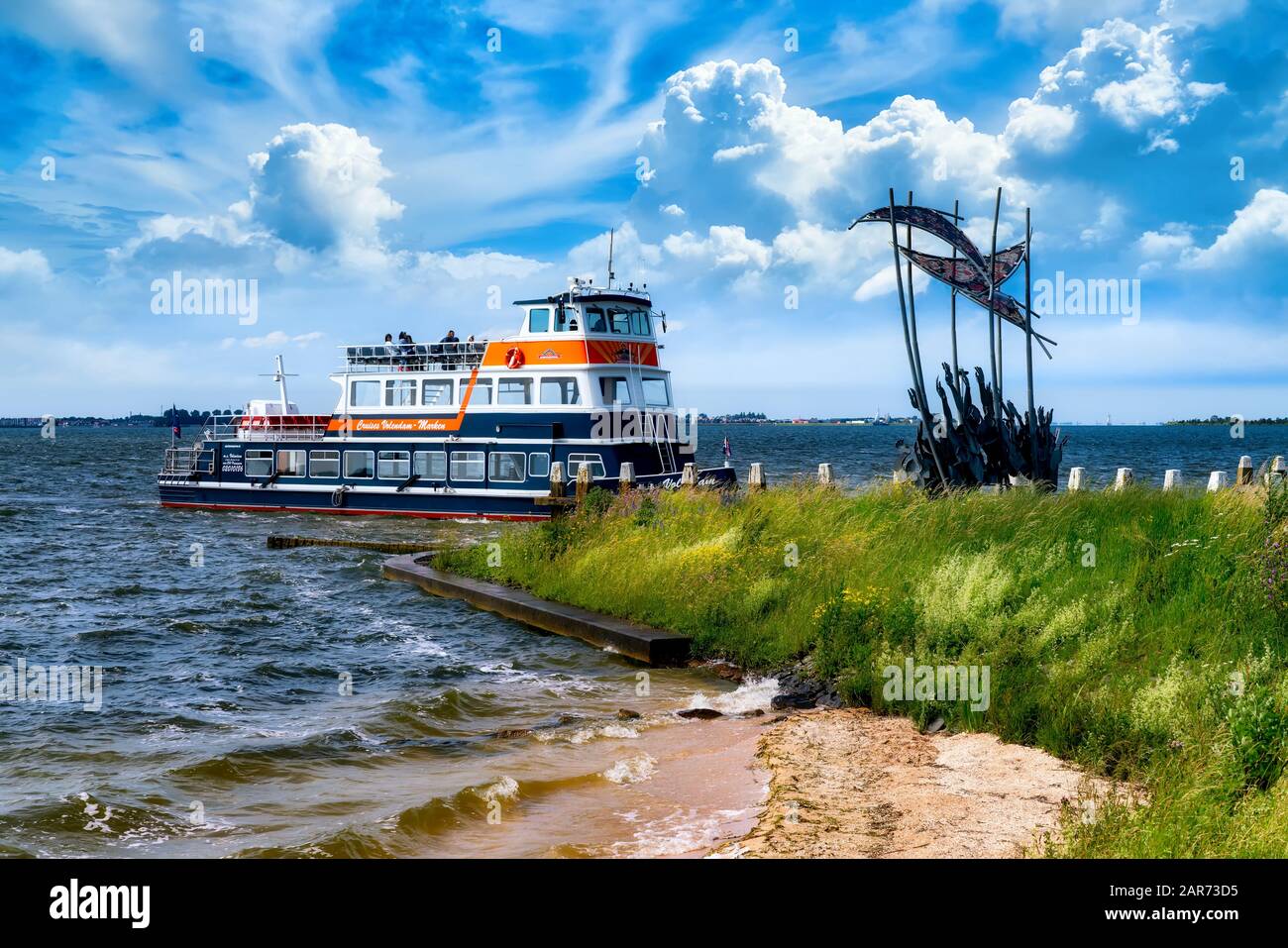 Marken, Netherlands, 06/20/2019: The tourist ferry service between 2 historical towns - Volendam and Marken, Netherlands . Ship entering the port of M Stock Photo