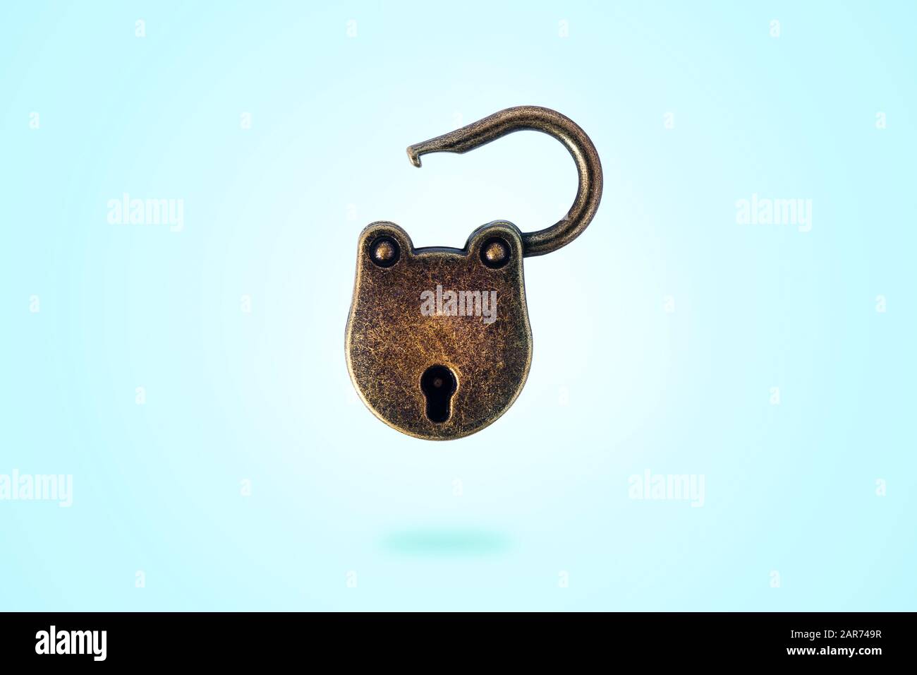 open bronze padlock levitate on a blue background Stock Photo