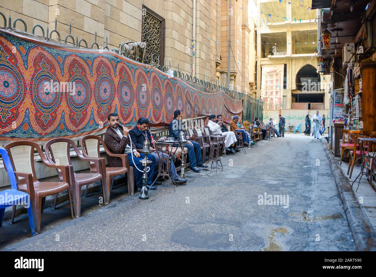 Cairo / Egypt - December, 2015: Men smoking hookah on the street Stock Photo