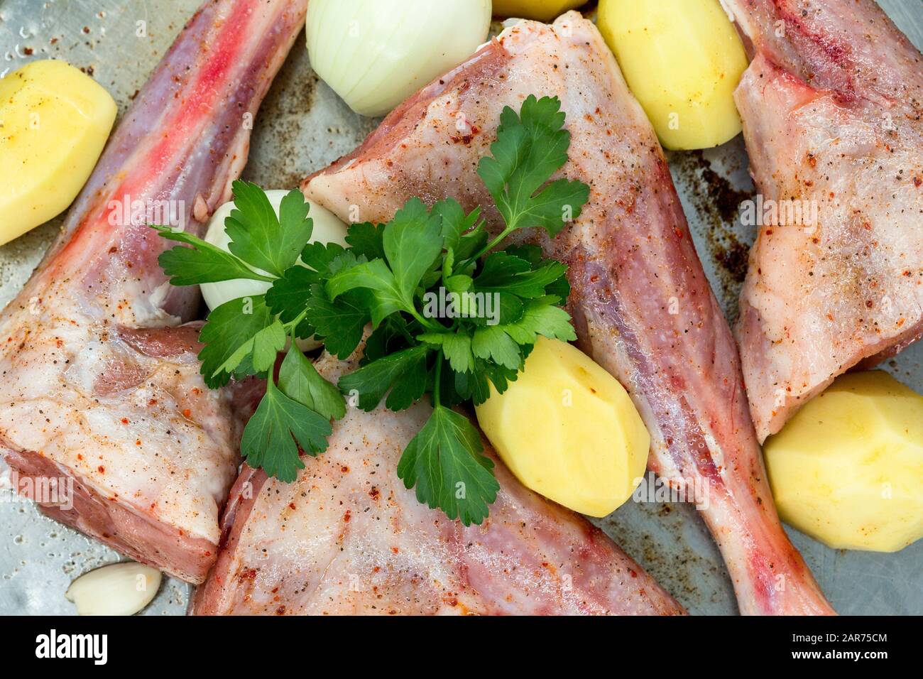 Lamb shank kebab on tray and potato onions around in Turkey Stock Photo