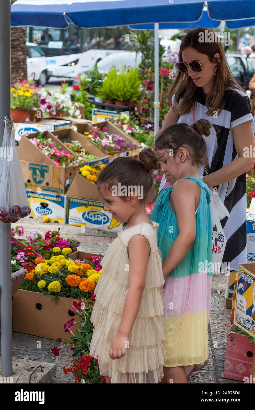 Mother and daughters buying flowers in the Market, Kotor, Montenegro Stock Photo