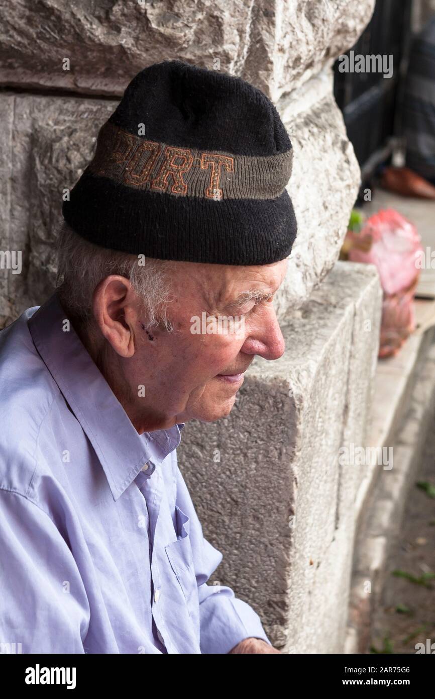 Old man wearing a woollen cap, Old Town Market, Kotor, Montenegro Stock Photo
