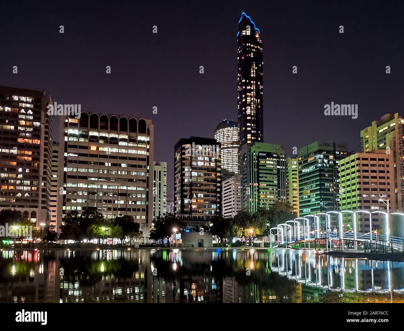 Abu Dhabi downtown cityscape reflected in the water at the Lake park Stock Photo