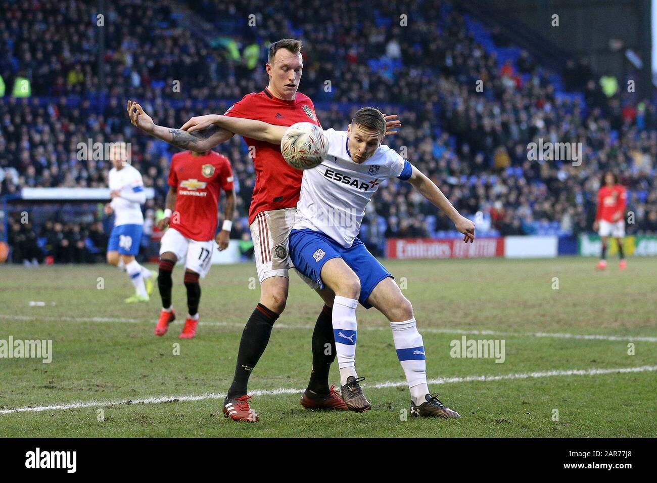 Birkenhead, UK. 26th Jan, 2020. Paul Mullin of Tranmere Rovers shields the ball from Phil Jones of Manchester United. The Emirates FA Cup, 4th round match, Tranmere Rovers v Manchester Utd at Prenton Park, Birkenhead, Wirral on Sunday 26th January 2020. this image may only be used for Editorial purposes. Editorial use only, license required for commercial use. No use in betting, games or a single club/league/player publications.pic by Chris Stading/Andrew Orchard sports photography/Alamy Live News Credit: Andrew Orchard sports photography/Alamy Live News Stock Photo