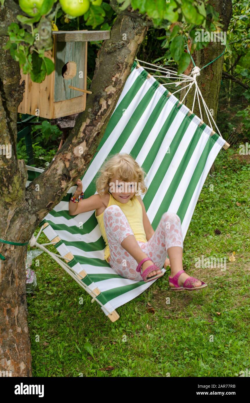 blond girl relaxing on hammock Stock Photo