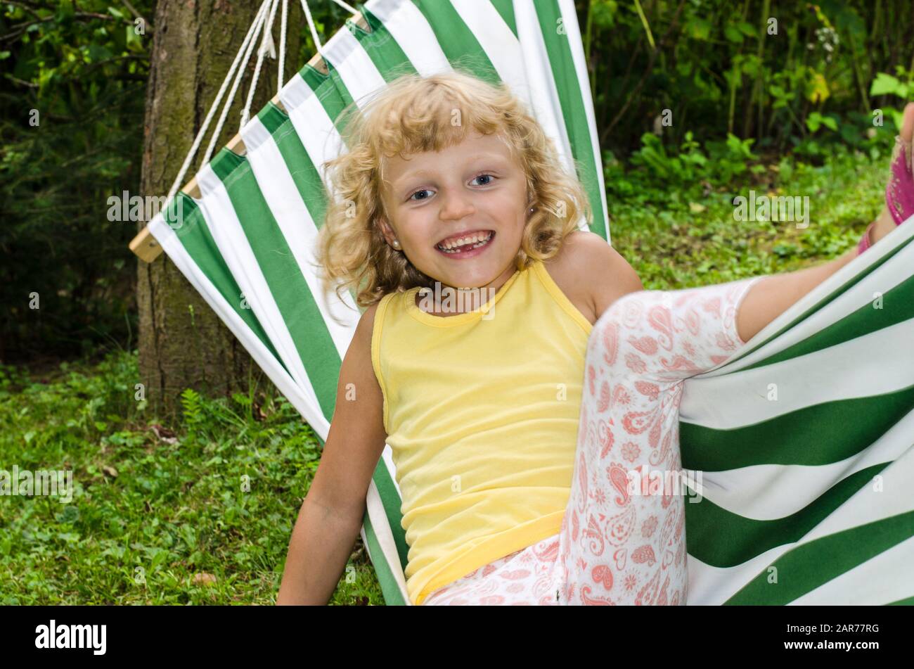 blond girl relaxing on hammock Stock Photo