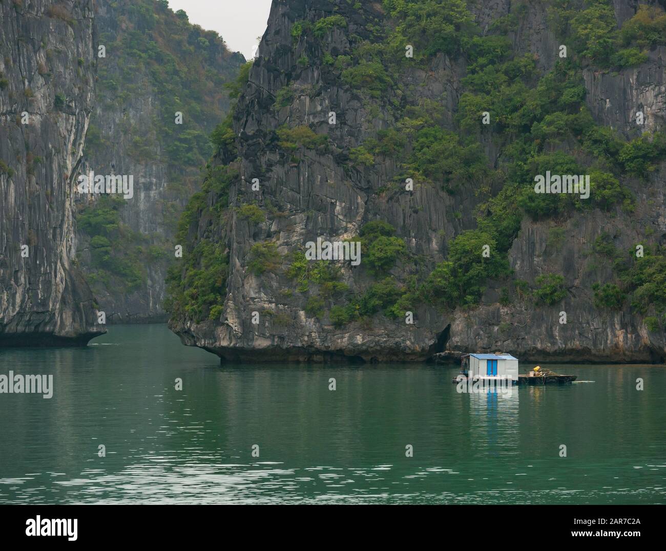 Fish farm with limestone rock karst cliffs, Lan Ha Bay, Vietnam, Asia