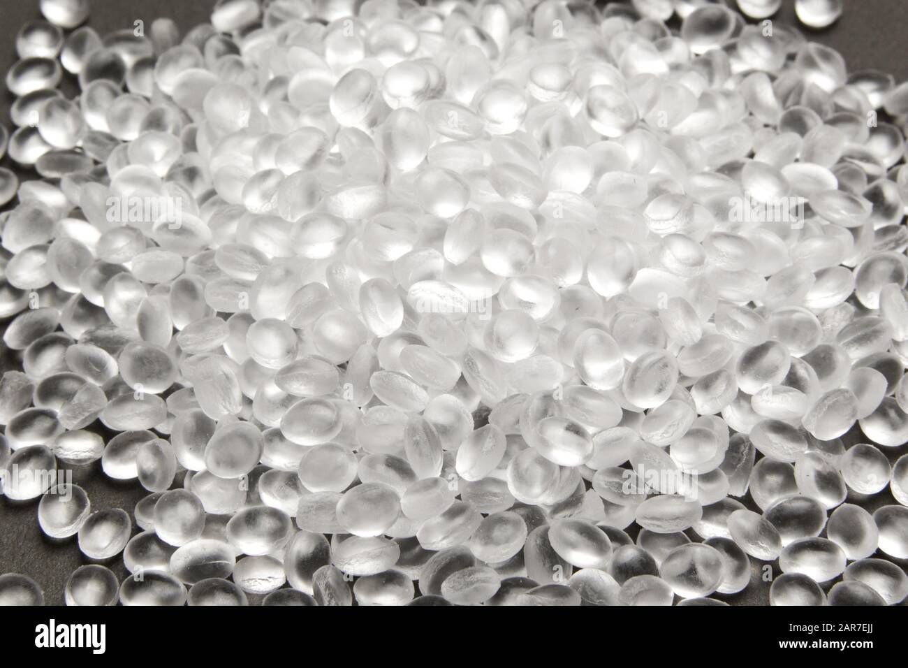 Transparent Polyethylene granules on dark .HDPE Plastic pellets. Plastic Raw material . IDPE. Stock Photo
