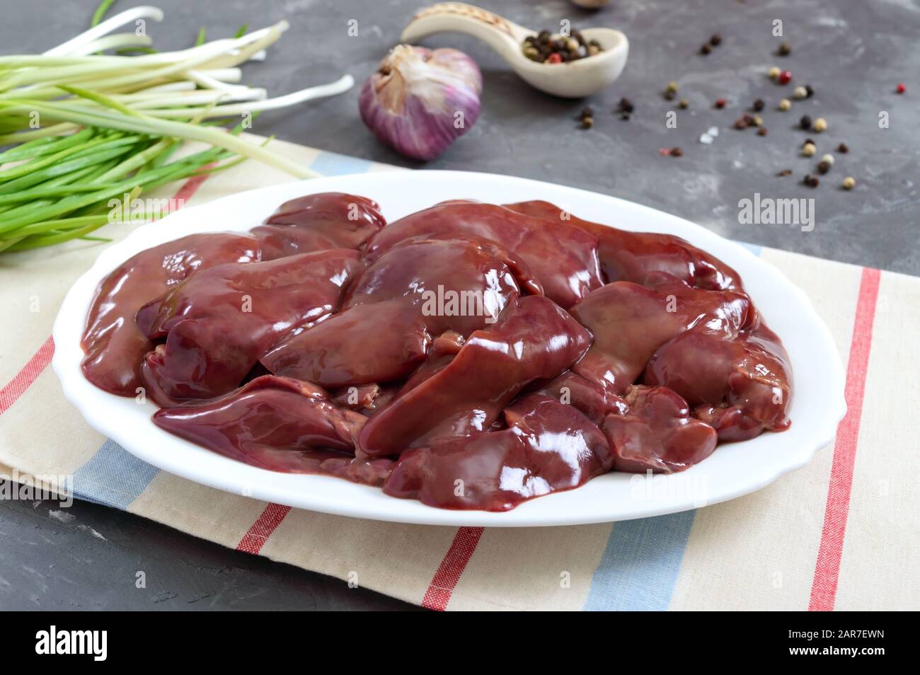 Raw chicken liver in a bowl on the table. Offal. Ready to cook. Dishes