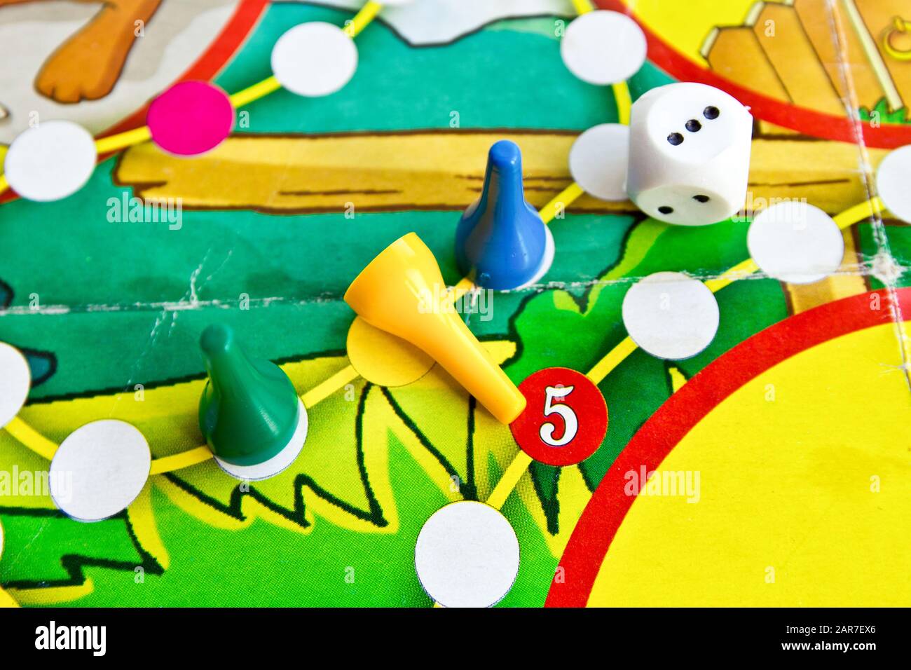 Blue, green and yellow plastic chips and dice in old Board games for