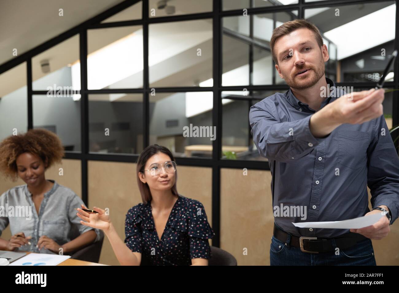 Caucasian male speaker making board presentation for listeners at briefing Stock Photo