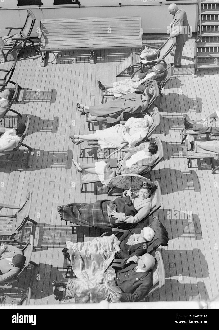 Sea voyage with MS Johan van Oldenbarnevelt to Norway  Passengers taking on deck a sun bath Date: 1933 Location: Norway Keywords: cruises, cruise ships, relaxation, travelers, ships, seats , tourism, sunbathing Stock Photo