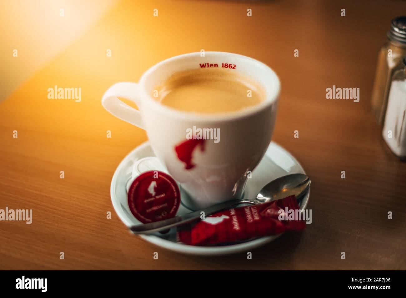 Würzburg, Germany - September 2019: A Cup of Julius Meinl espresso with the with a spoon, a cookie and milk to enjoy the coffee. Stock Photo