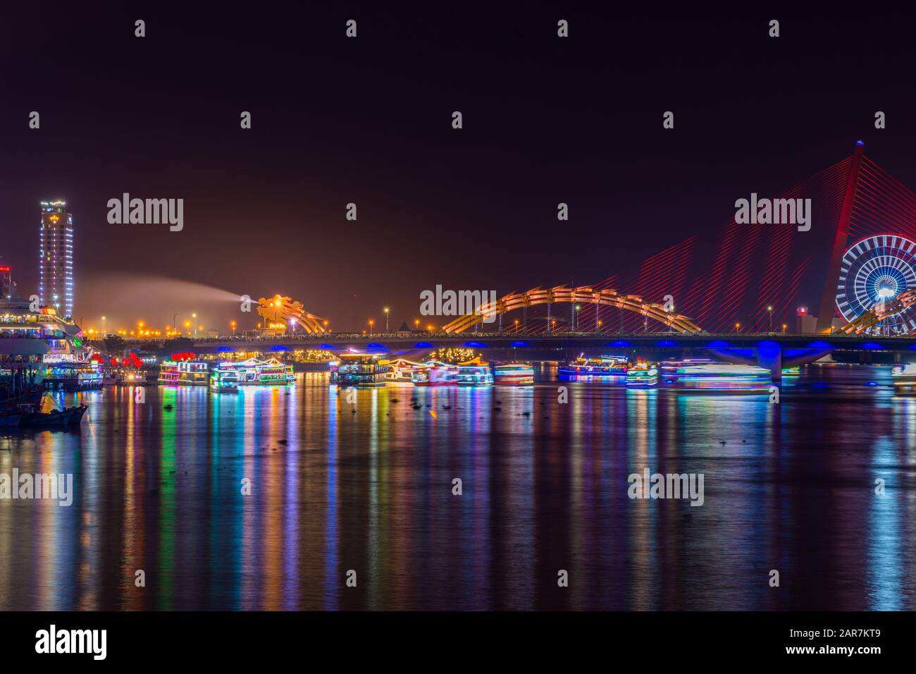 Dragon Bridge at night the icon of the Da Nang City, Vietnam. Dragon breathes out stream of water during weekend showtime. Stock Photo
