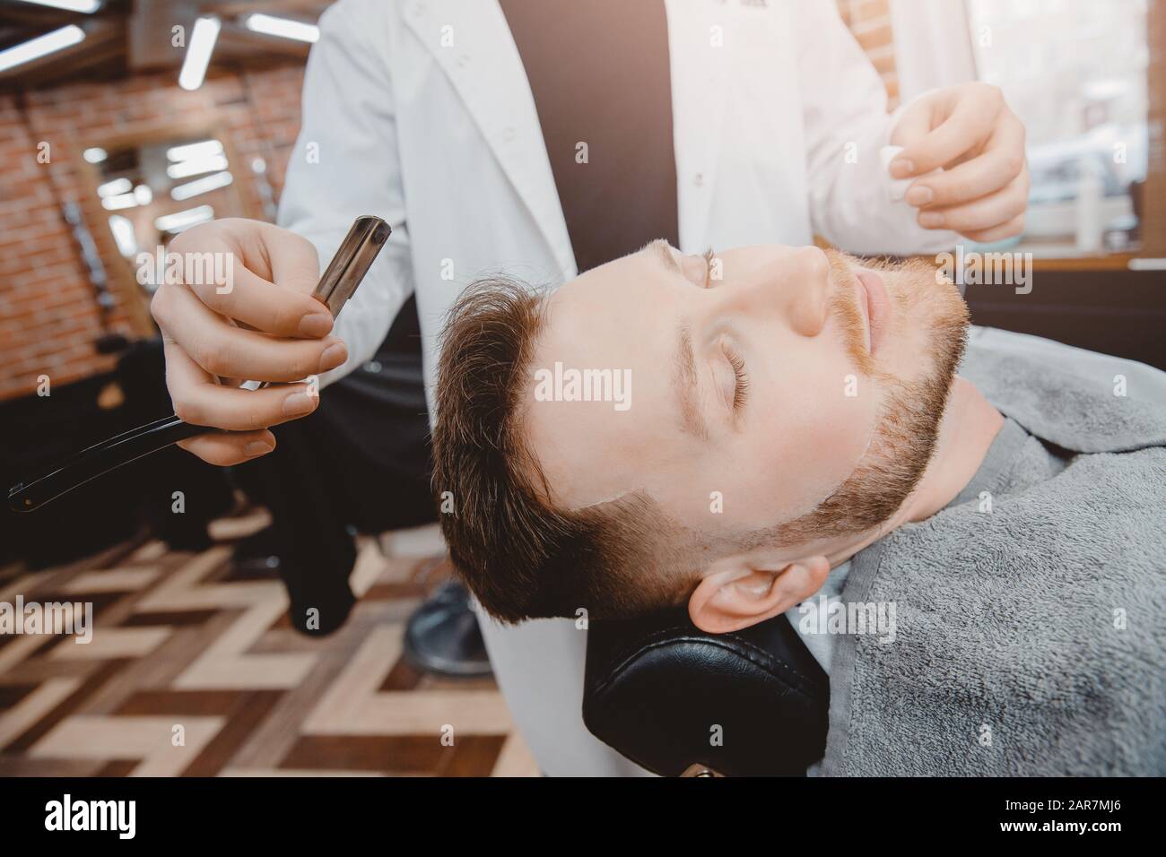 Barber process shaving razor bearded hipster man in barbershop Stock ...