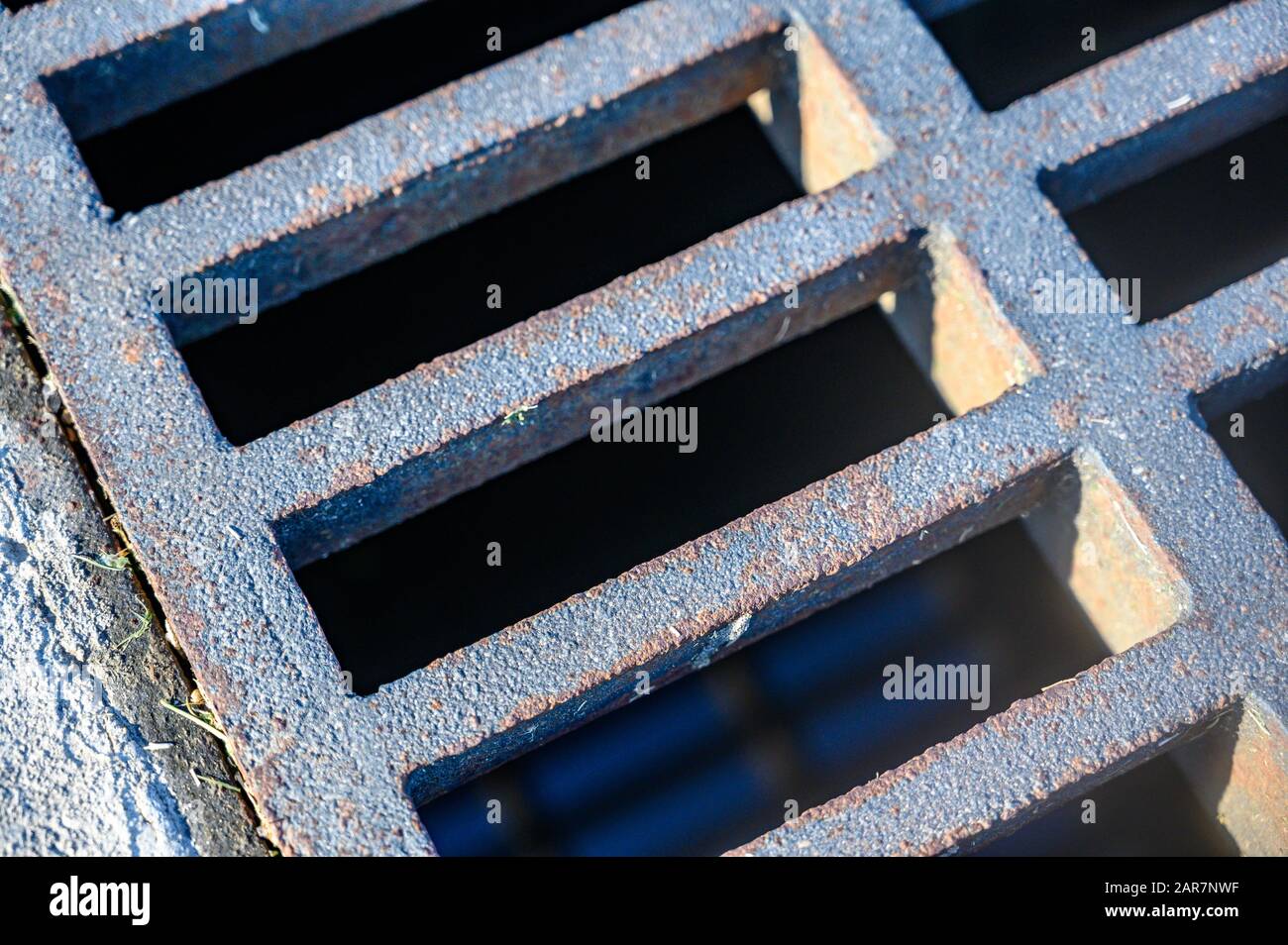Storm water cast iron grate over collection piping Stock Photo