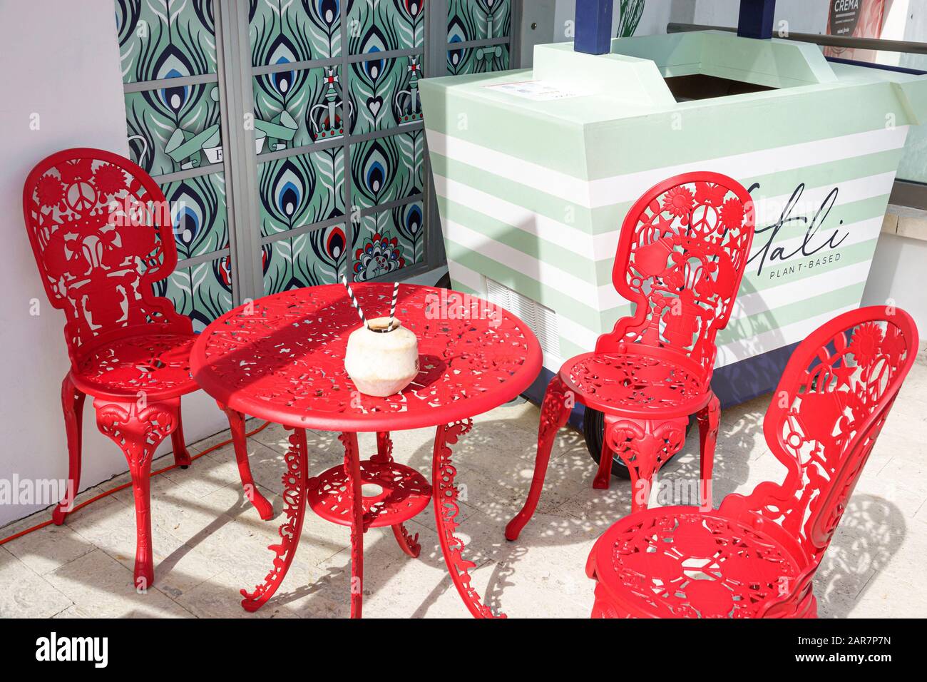 Miami Beach Florida,matching red chairs table metal,garden furniture,visitors travel traveling tour tourist tourism landmark landmarks,culture cultura Stock Photo