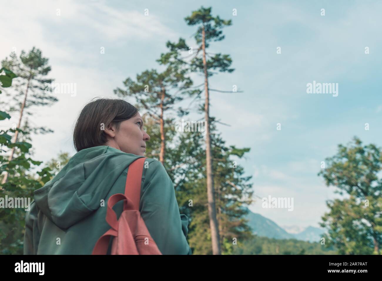 Female hiker walking outdoors in woods on summer vacation Stock Photo