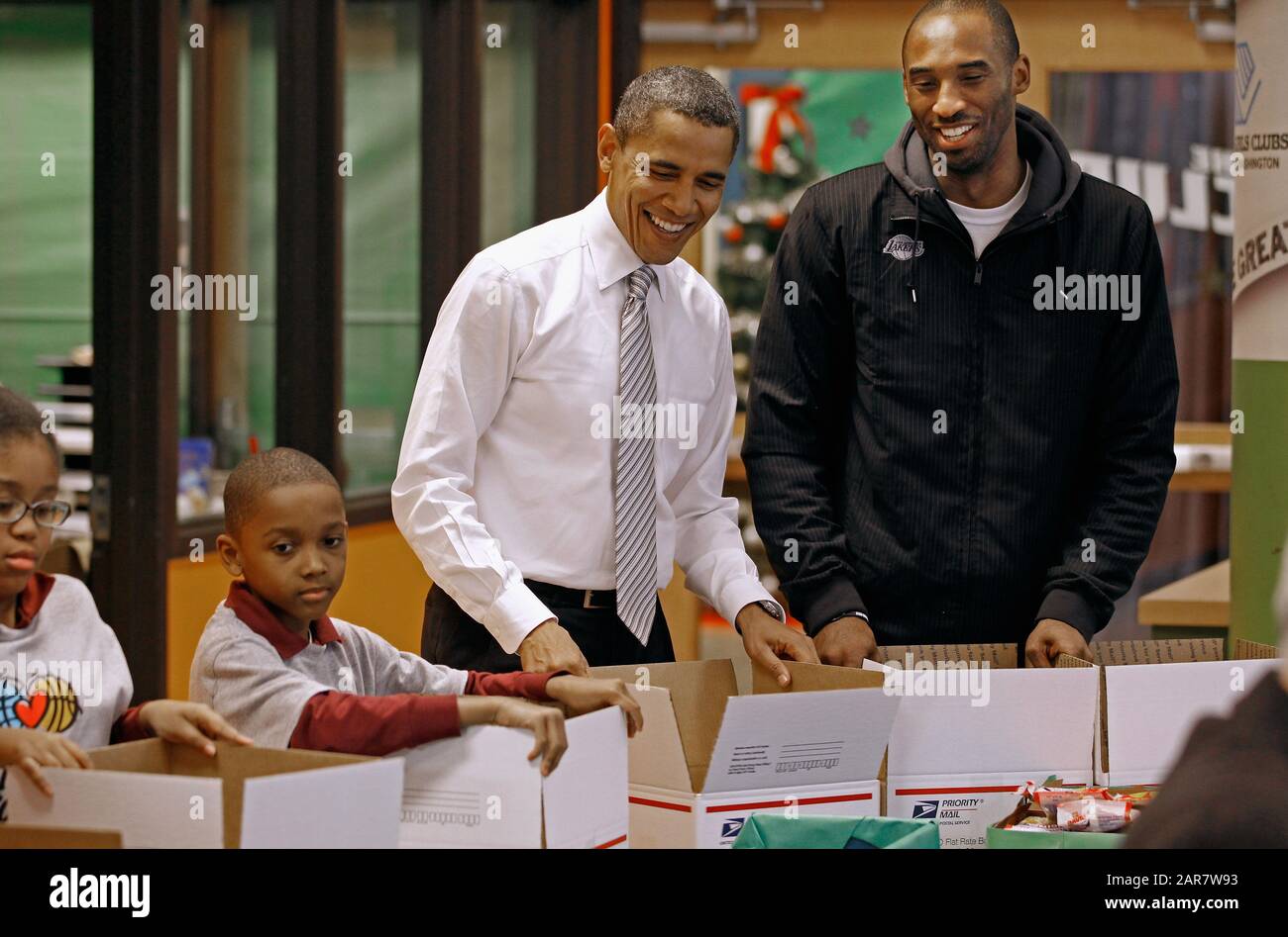 Washington, DC. 13th Dec, 2010. United States President Barack Obama (C) and Los Angeles Lakers guard Kobe Bryant help children volunteers fill care packages during a NBA Cares service event at the Boys and Girls Club at THEARC, December 13, 2010 in Washington, DC. Bryant and all the members of the 2010 NBA Championship Lakers team volunteered on projects at the club before being honored by the president for their victory. Credit: Chip Somodevilla - Pool via CNP | usage worldwide Credit: dpa/Alamy Live News Stock Photo