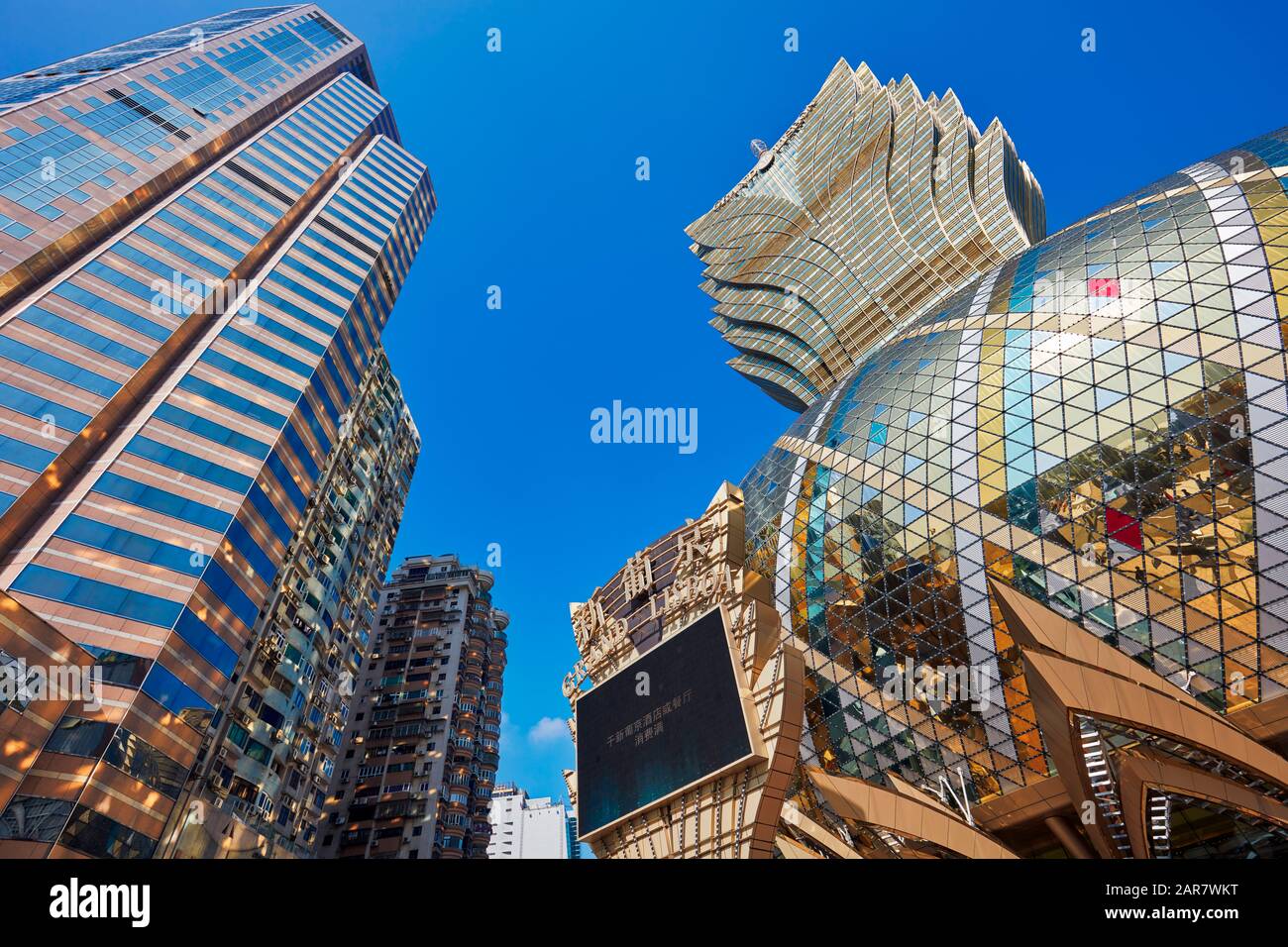 Shiny golden dome of the Hotel Grand Lisboa and nearby high-rise buildings. Macau, China. Stock Photo