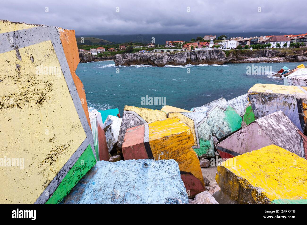 Los Cubos de la Memoria, The Memory Cubes, by Agustín Ibarrola in port of Llanes with lighthouse, Asturias, Spain Stock Photo