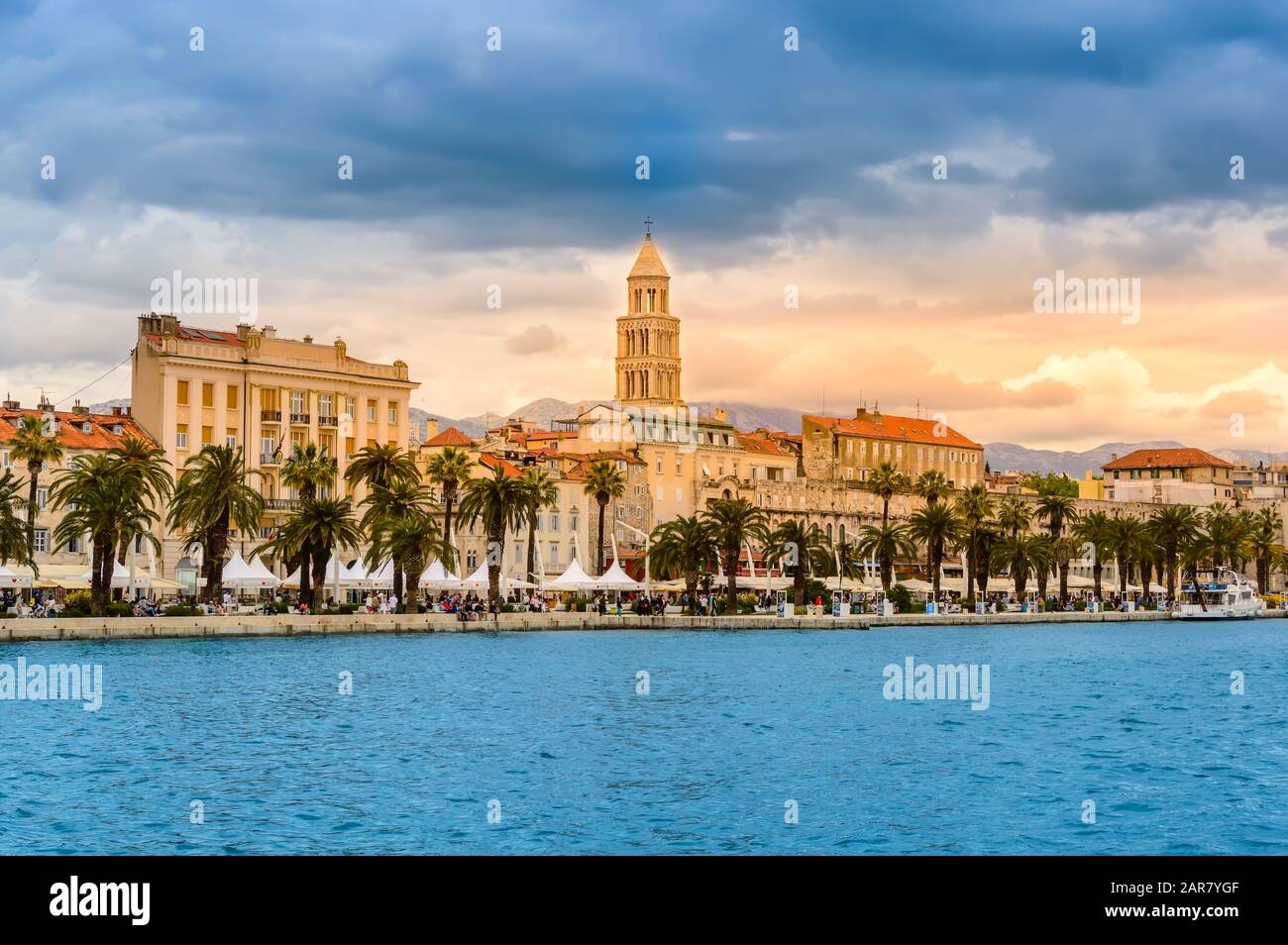 Split, Croatia - May 21, 2019: Split old town with Saint Domnius Cathedral, colorful buildings, Riva Promenade and palm trees. Vivid waterfront evenin Stock Photo