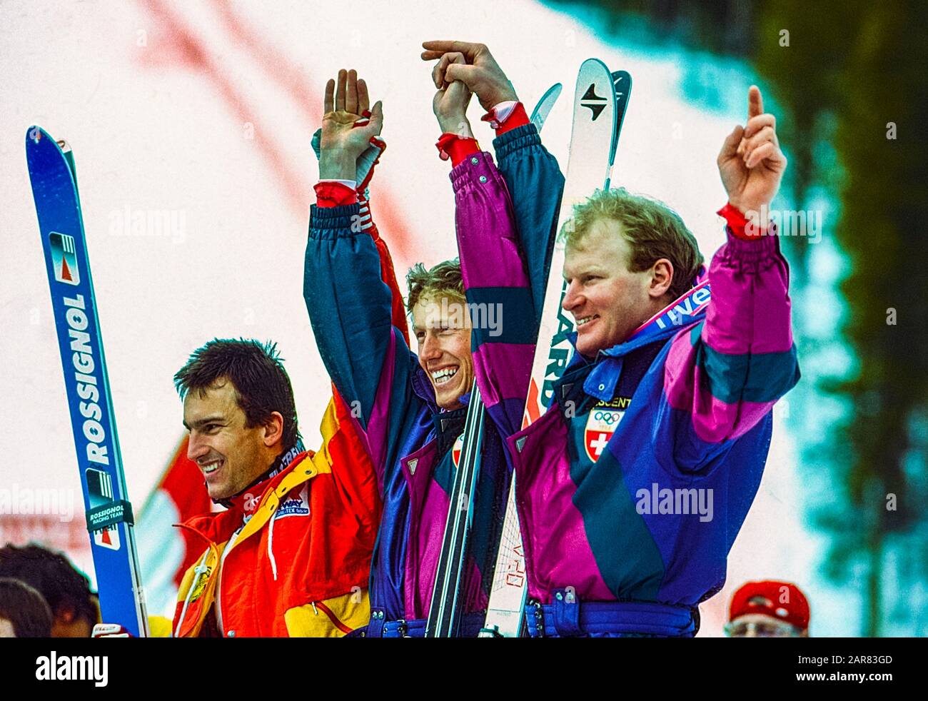 Pirmin Zurbriggen of Switzerland (C)  wins the gold medal in the downhill, Peter Müller (SUI) -R- Silver, Franck Piccard. (FRA) -L- Bronze at the 1988 Olympic Winter Games. Stock Photo