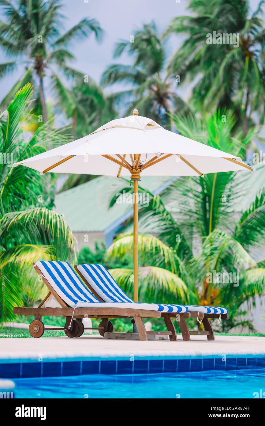 Beach lounge chairs on beautiful tropical luxury resort Stock Photo Alamy
