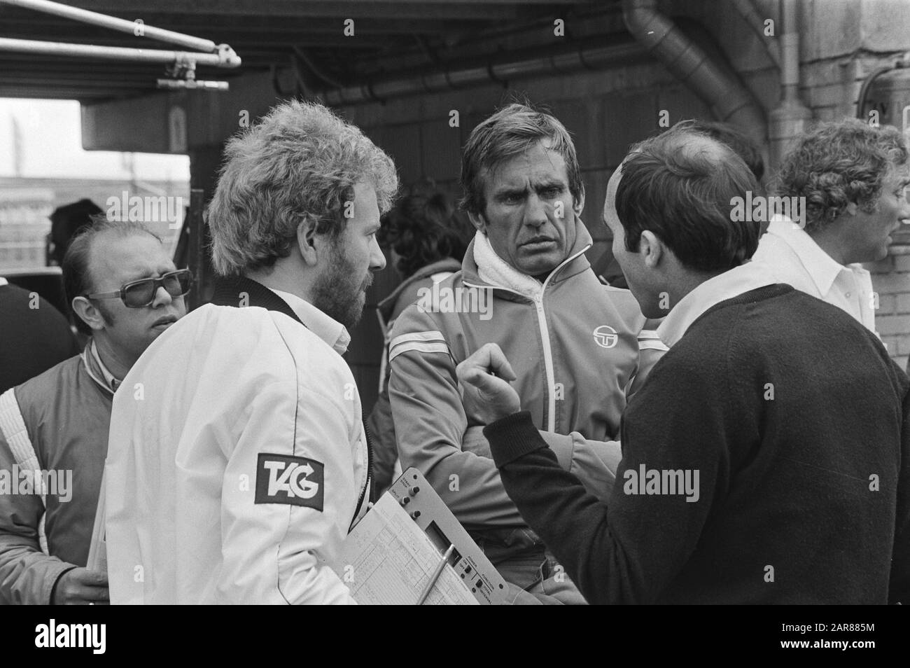 Team owner Frank Williams (right) in conversation with Williams-Ford Formula One driver Carlos Reutemann (middle) during the training of the Zandvoort Grand Prix in 1981.; Stock Photo