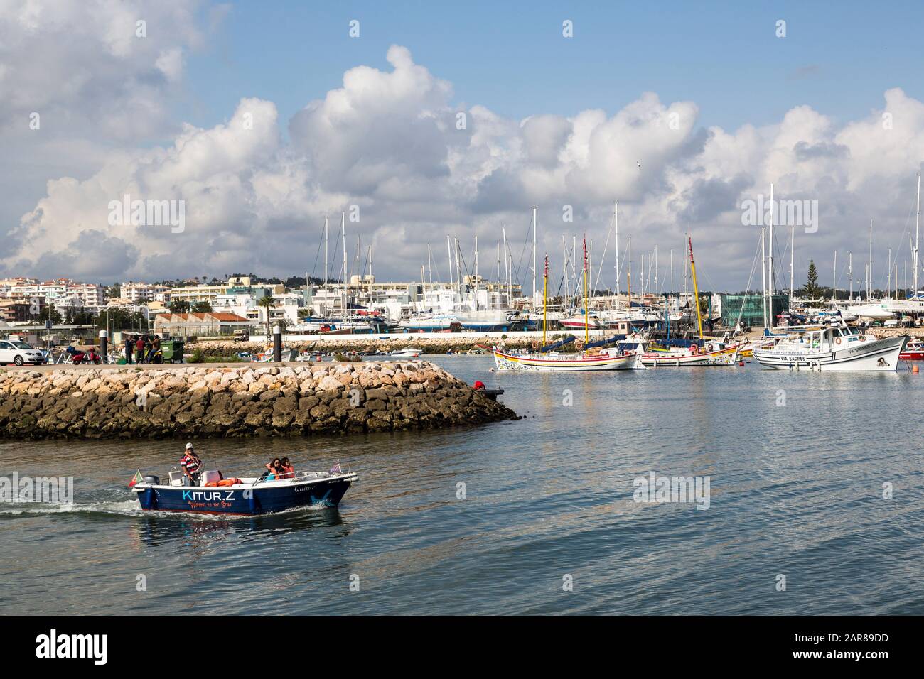Sightseeing tourist boat leaving harbour, Lagos, Algarve, Portugal Stock Photo