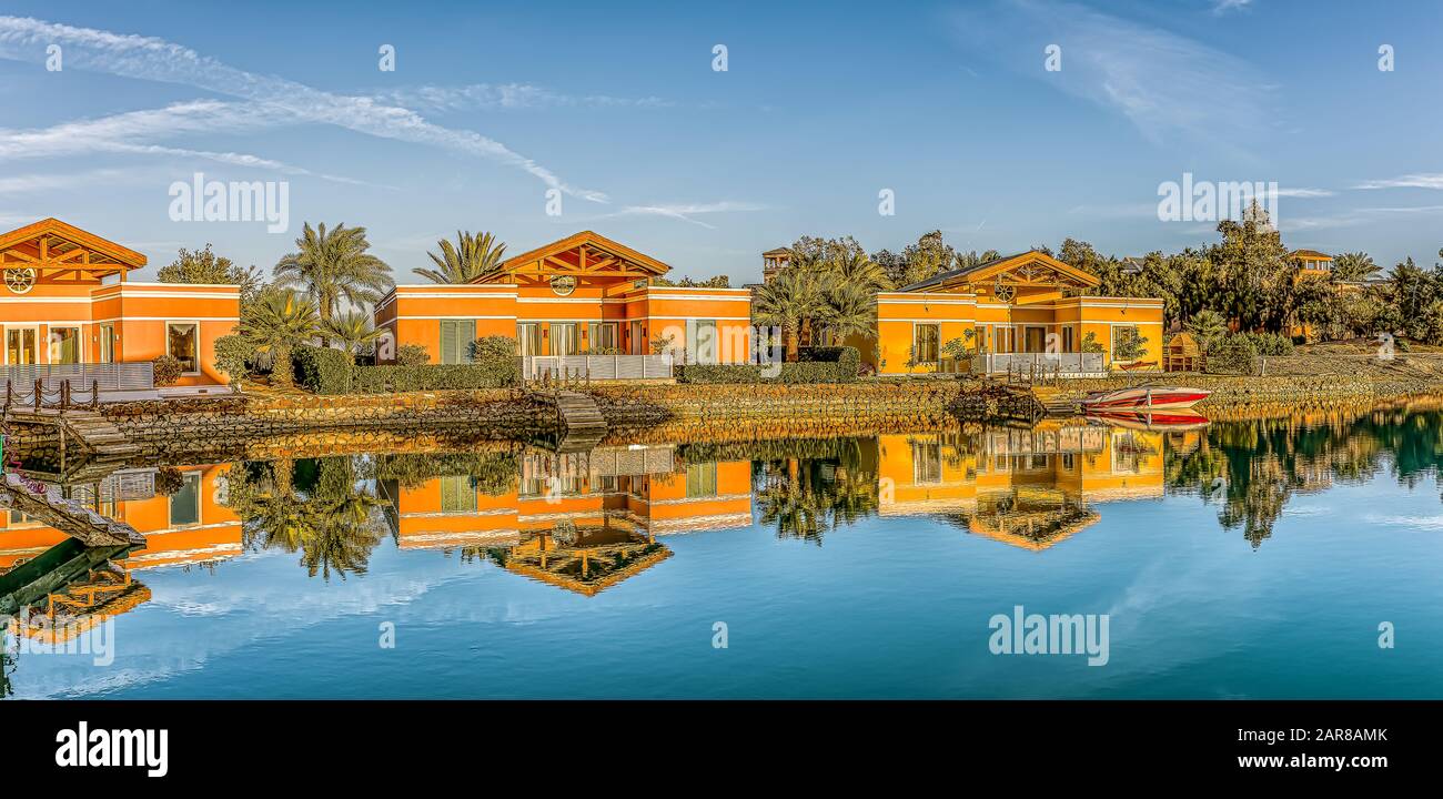 three luxurious  bungalows in the soft evening light, reflecting in the red sea lagoon in el Gouna, Egypt, January 12, 2020 Stock Photo