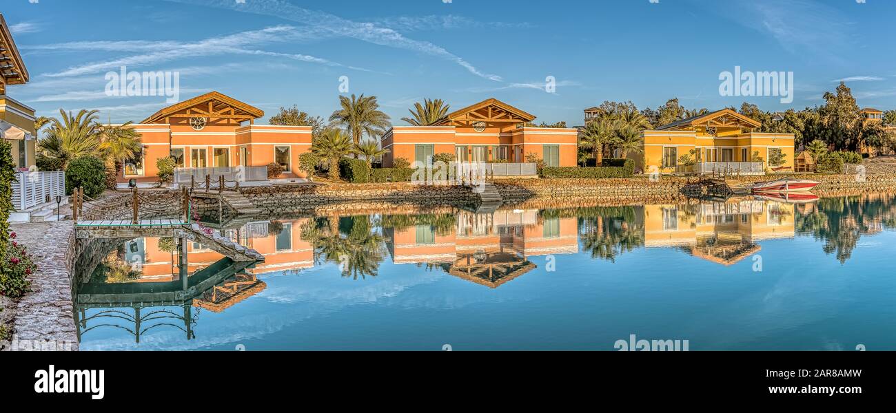 three luxurious bungalows in the soft evening light, reflecting in the red sea lagoon in el Gouna, Egypt, January 12, 2020 Stock Photo