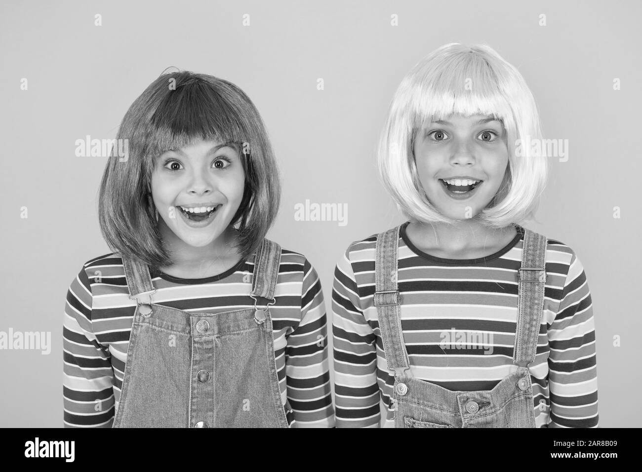 Cheerful friends in bright colorful wigs. Anime cosplay party concept.  Happy childhood concept. Anime culture influence. Invitation for anime  party. Happy little girls smiling faces. Anime fan Stock Photo - Alamy
