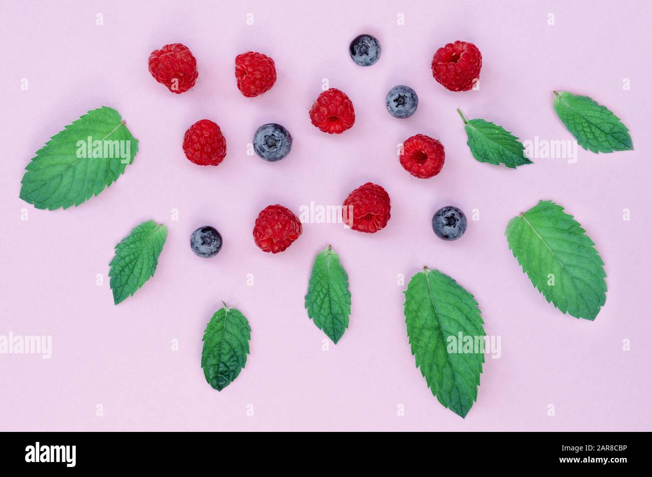 Raspberry Flat Lay Flat lay composition of raspberries and blueberrieson a pink background ...