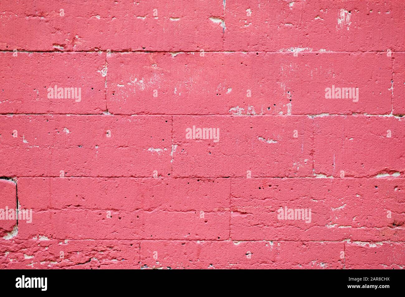 Brick wall scuffed painted pink texture background Stock Photo