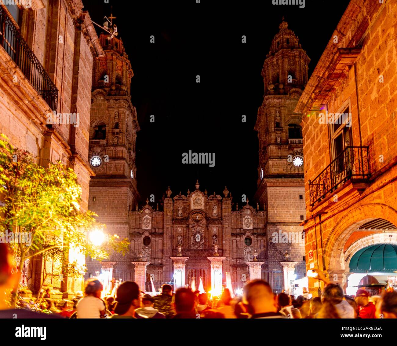 People gather infront of the Morelia Cathedral at night, enjoying the weekend, in the state of Michoacan, Mexico Stock Photo