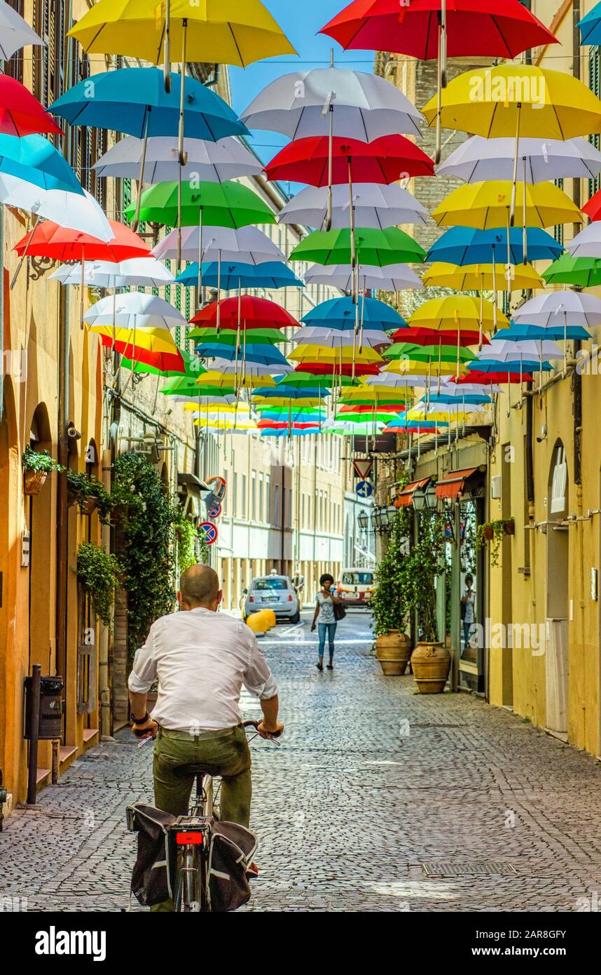 RAVENNA, ITALY - JUNE 19,2019: man driving bicycle under colorful hanging  umbrellas in street of historical center of Ravenna Stock Photo - Alamy