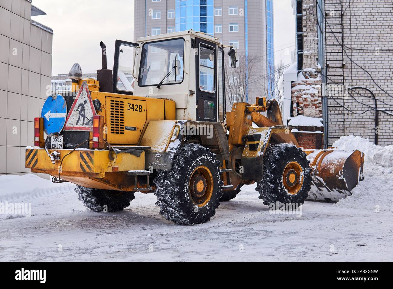 Perm, Russia - Jauary 26, 2020: snow removing loader stands in a city courtyard Stock Photo