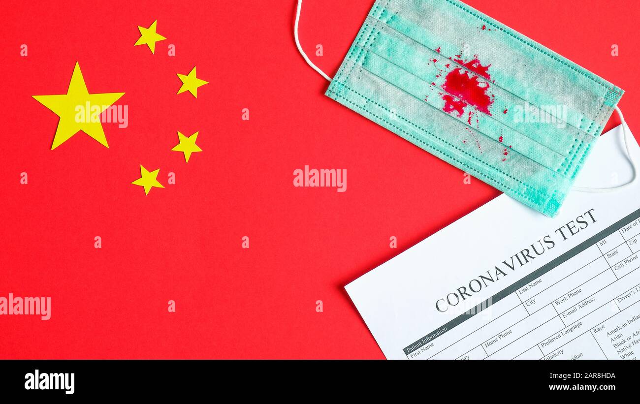 Coronavirus test medical form, protective breathing mask with traces of blood from coronavirus cough on flag of China. Flu pandemic infection, Novel C Stock Photo