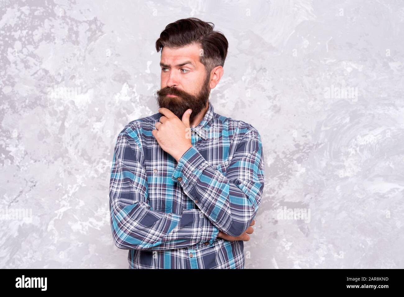 unshaven man care his look. professional hairdresser in checkered shirt.  brutal bearded man grunge background. serious man with lush beard and  moustache. confident male hipster after barbershop Stock Photo - Alamy