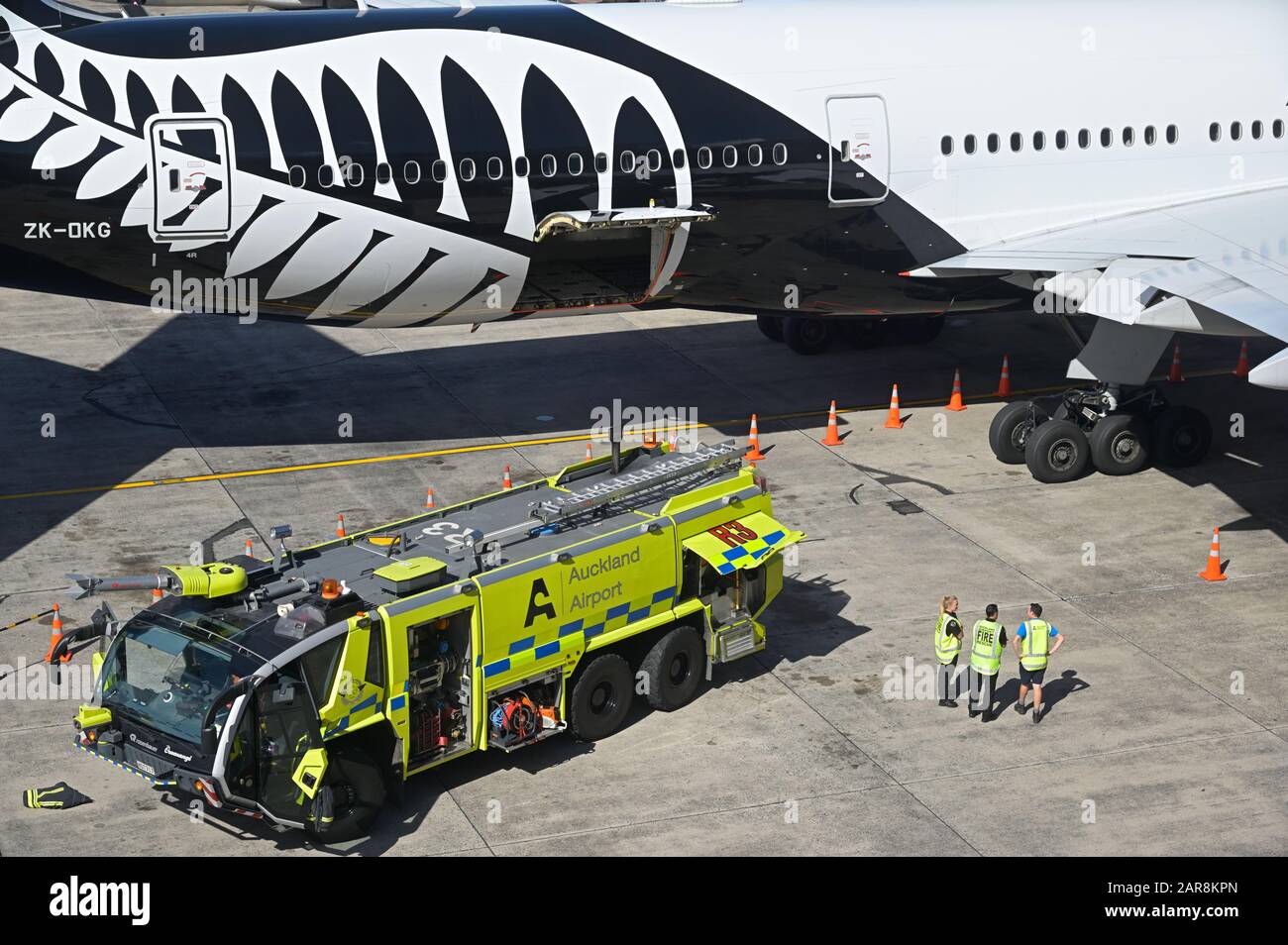 Emergency drill of the airport fire brigade on an ANZ Boeing 777-200 ER, Auckland airport NZ Stock Photo