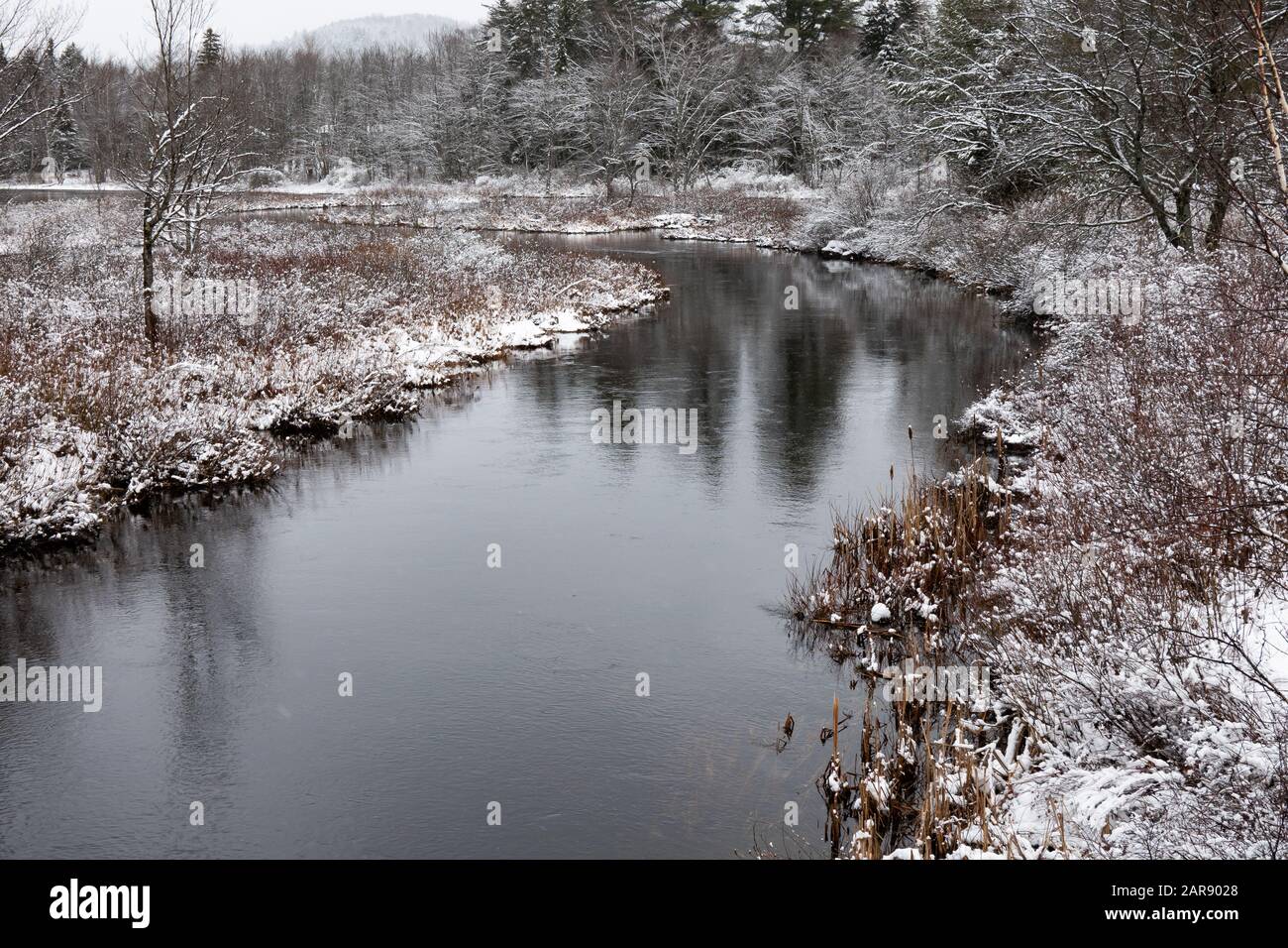A snowy winter scene of the Sacandaga River near Speculator, NY USA in the Adirondack Mountains. Stock Photo