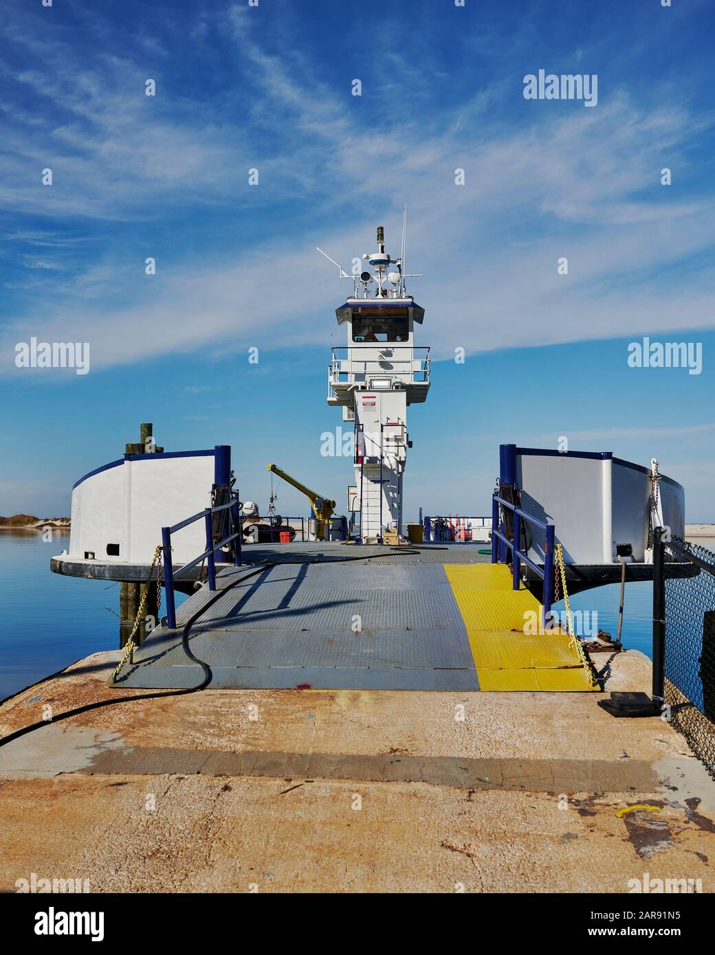 Small empty car ferry waiting to load at the ferry dock on Dauphin