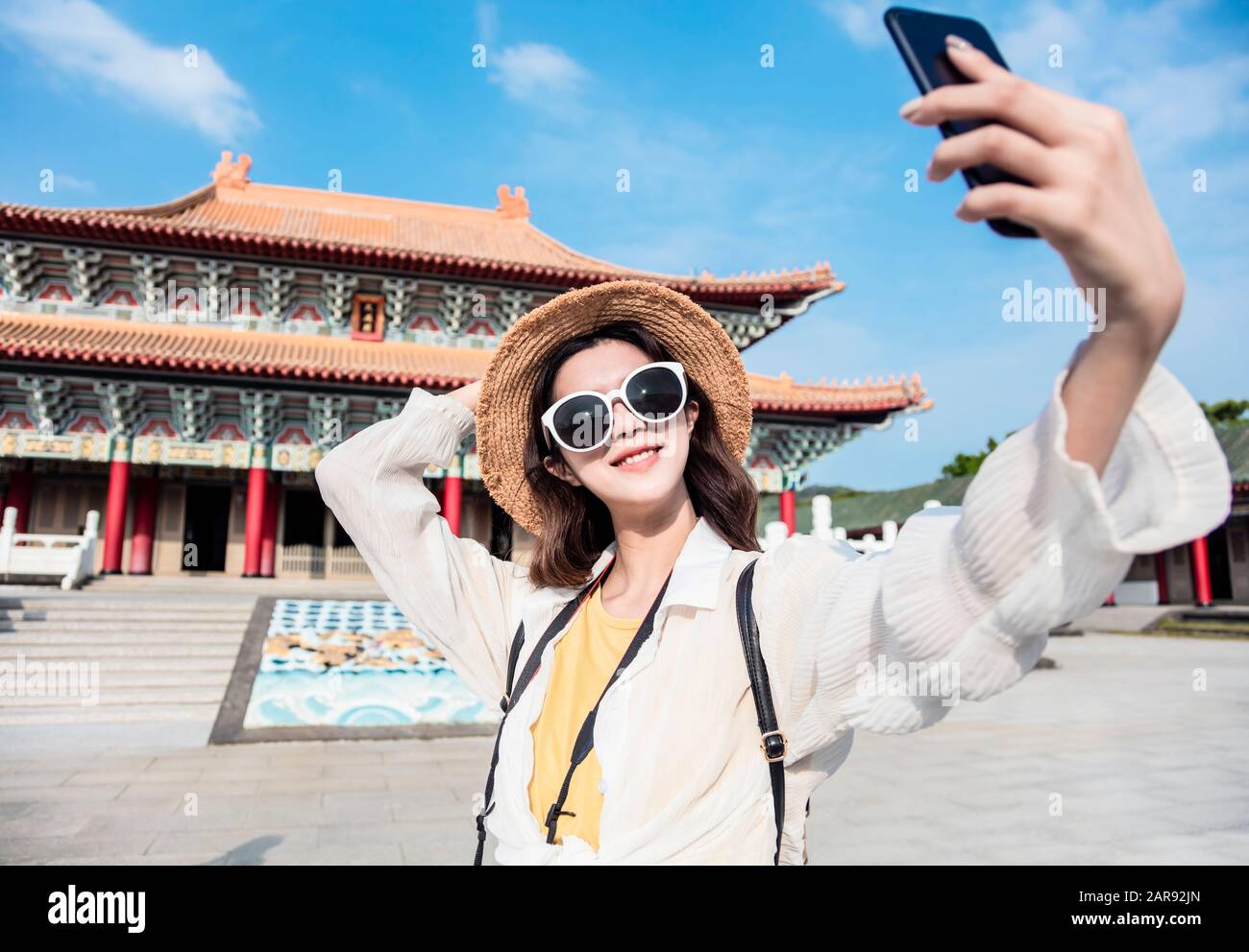 happy asian female traveler taking selfie and temple Stock Photo