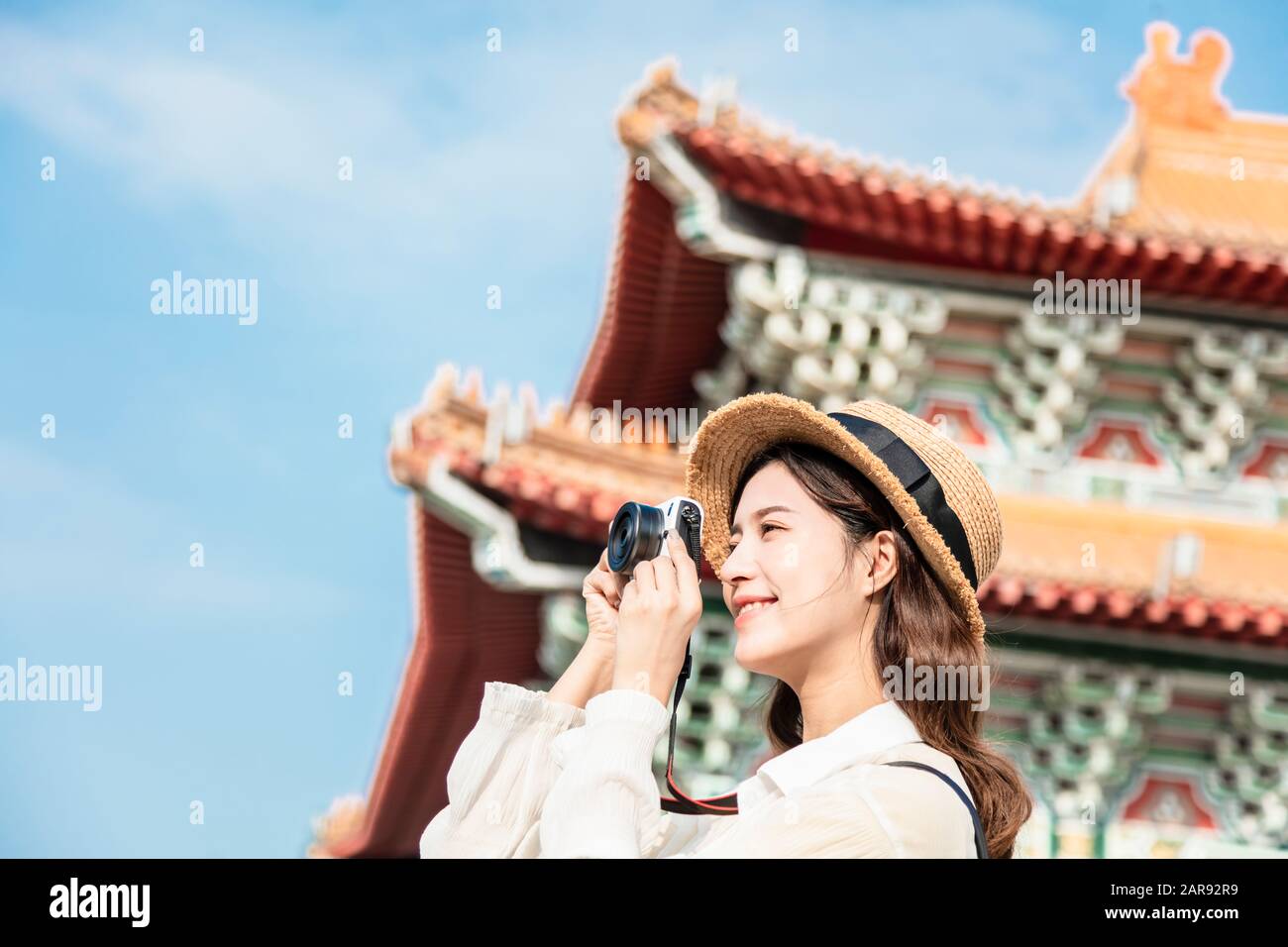 asian female traveler photographing temples at  Asia Stock Photo